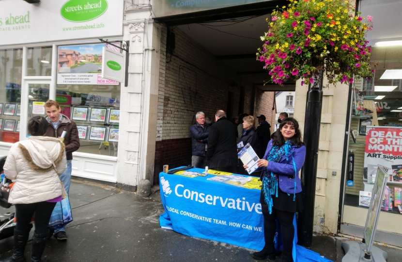 street stall visitors sheltering from the rain!