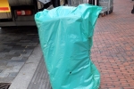 Bin covered in green bag in Purley High Street