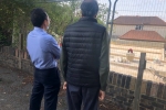 Residents looking at the concrete plinth built at 22 Briton Crescent