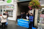 street stall visitors sheltering from the rain!